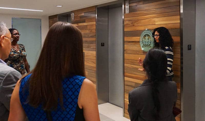 Professionals talking in lobby of u. S. Green building council headquarters - 2030 challenge