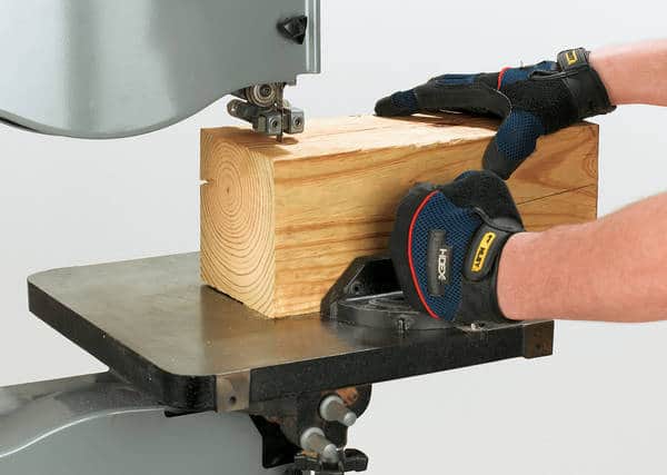 Person slicing timber - end grain flooring