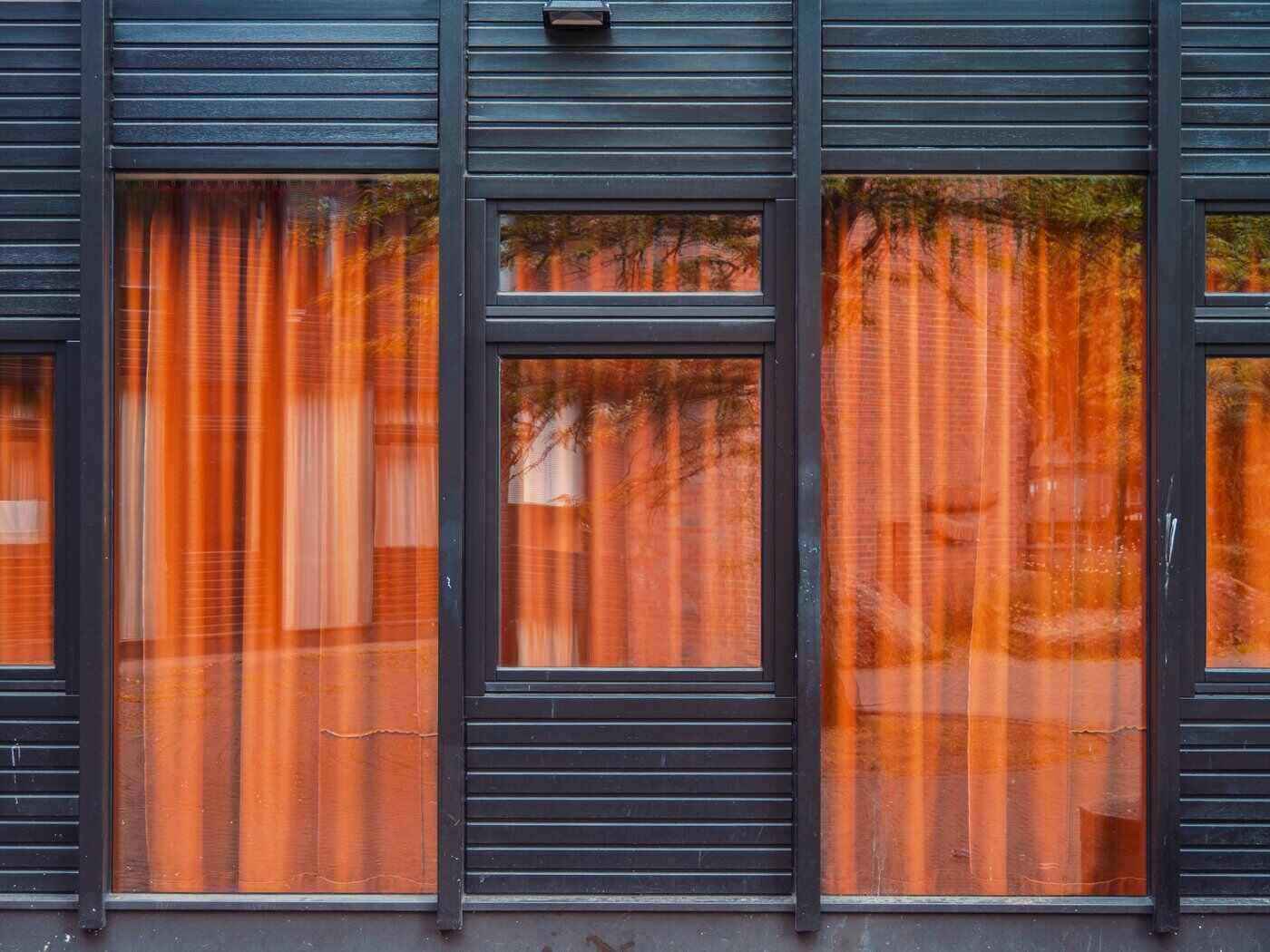 An Intro To Modular Homes In Canada 4 Front of home with windows and orange curtains - modular homes in canada
