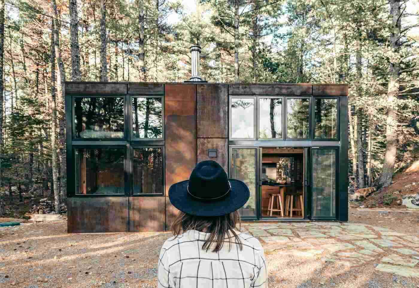 An Intro To Modular Homes In Canada 2 Woman standing in front of modern cottage - modular homes in canada