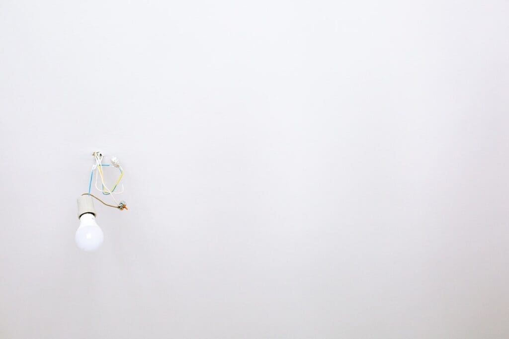 Bare lightbulb against white wall - which energy-saving upgrades pay for themselves