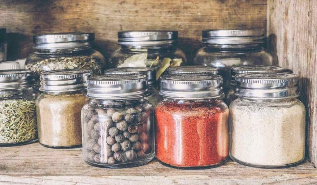 Row of glass jars with spices - 5 eco-friendly ways to organize your home