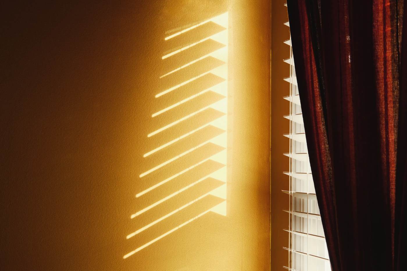 How Window Blinds Can Help Save Energy 2 Close up of window with blinds and drapes - how blinds can help save energy