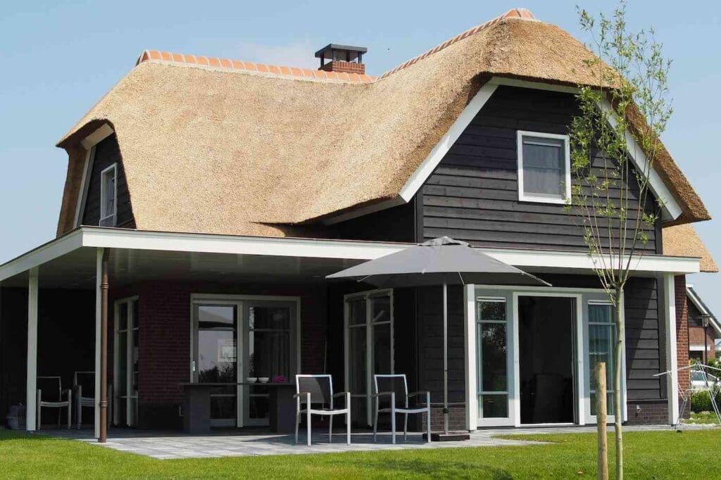 House with thatched roof - home insurance for green homes