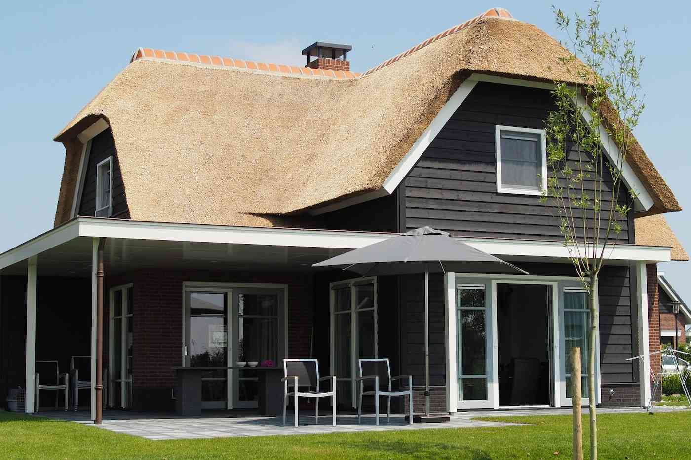 Are Green Homes More Expensive To Insure? What You Should Know About Home Insurance 2 House with thatched roof - home insurance for green homes