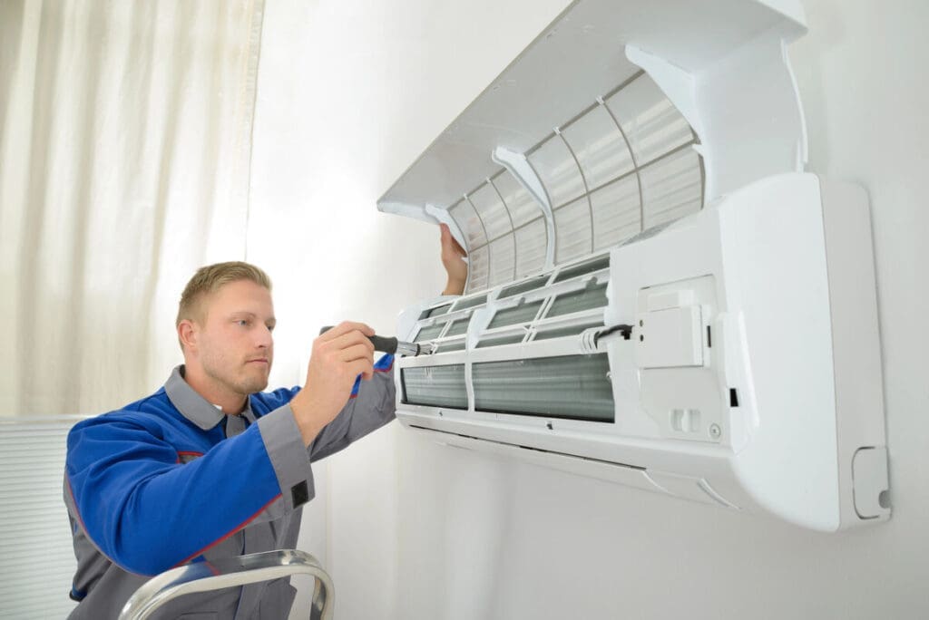 6 Tips To Avoid Costly Ac Repairs 4 Repairman fixing air conditioner