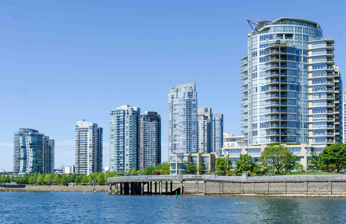 How Much Do Condos Appreciate Per Year? Forecasting Your Condo’s Potential In Canada 2 Condos on vancouver skyline