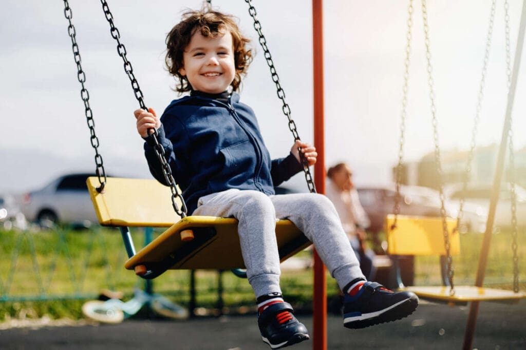 How To Choose A Sustainable Kids Swing Set 5 Boy on swing set