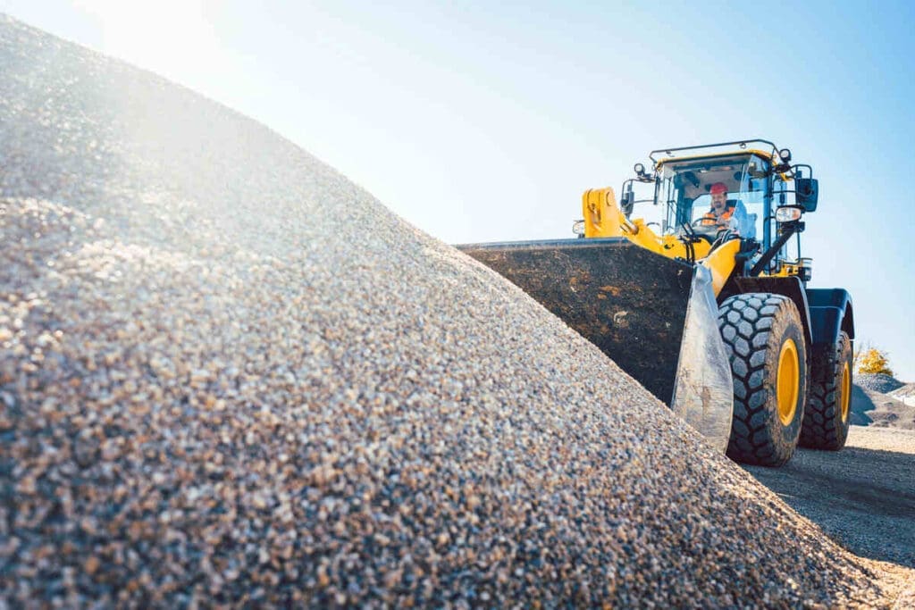 Front loader shovelling gravel