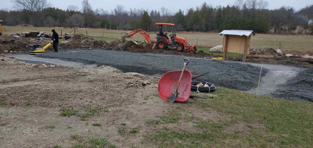 Is A Slab On Grade A Better Option When It Comes To Mitigating Flood Risk? 3 Tamping gravel for foundation of house