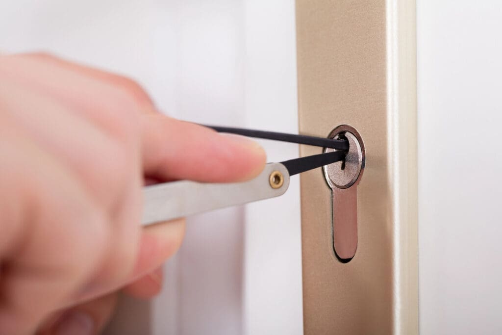 Locksmith picking door lock of house