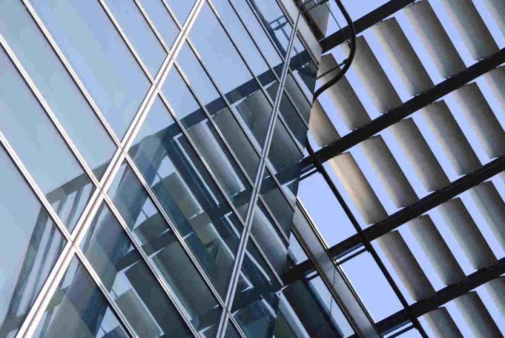 Exterior of modern building showing louvers reflected in windows