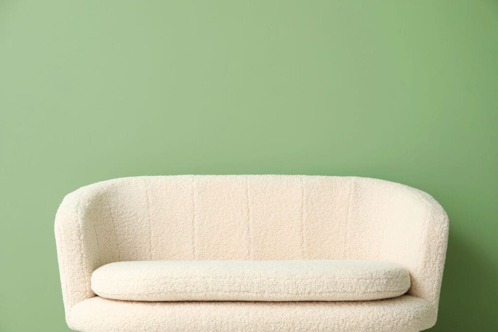 Sofa on green wall