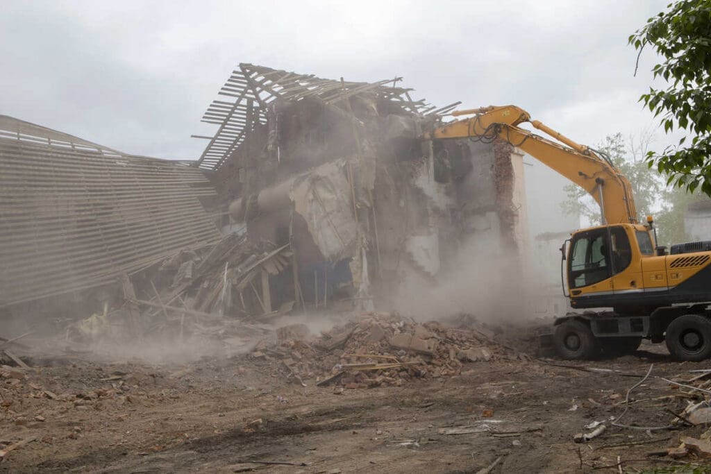 Demolishing a house with excavator