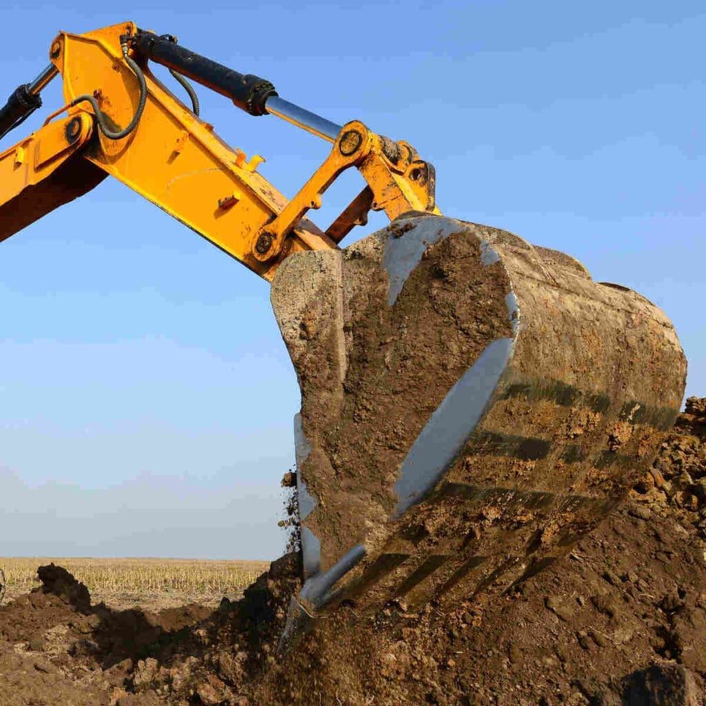 Excavator moving soil-earth-dirt from construction site