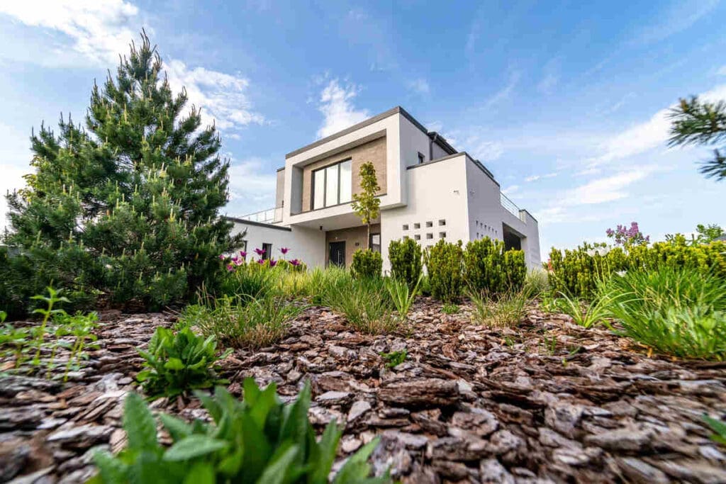 Understanding The Terminology Behind Climate-Resilient Buildings 7 House with mulch and trees