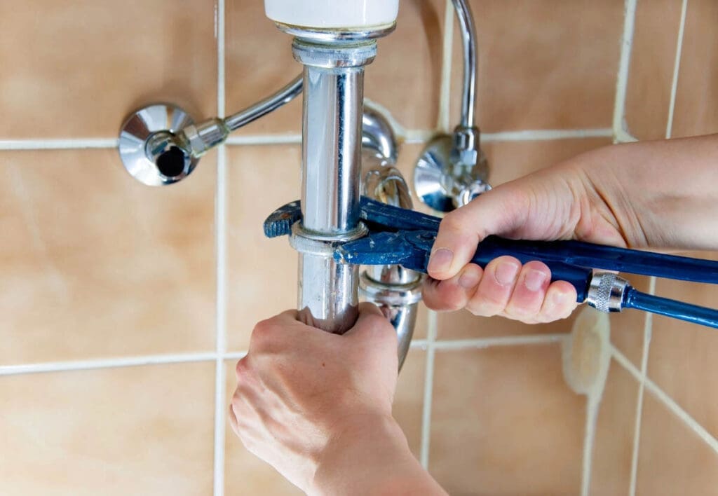 Understanding Common Plumbing Issues 5 Plumber repairing water pipe of sink