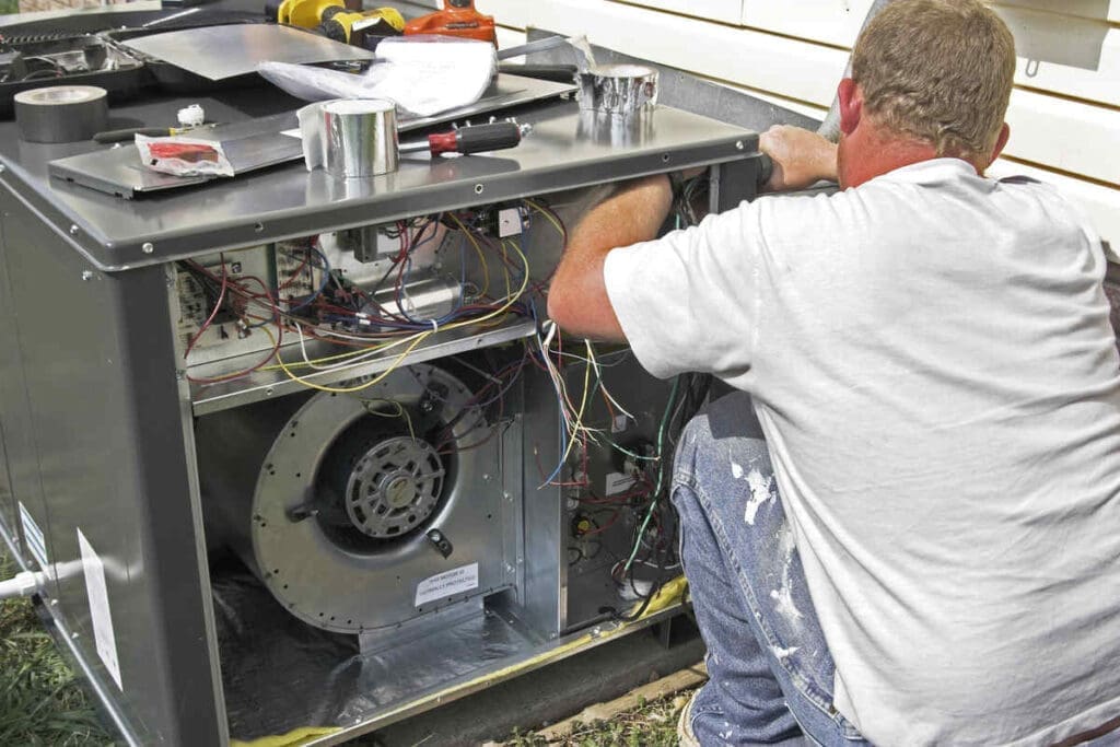 Hvac tech installing heat pump compressor