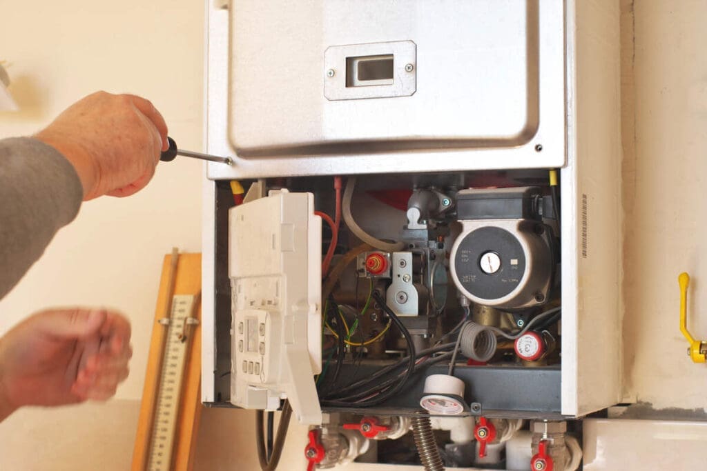 HVAC tech repairing furnace