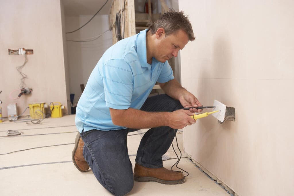 electrician installing outlet